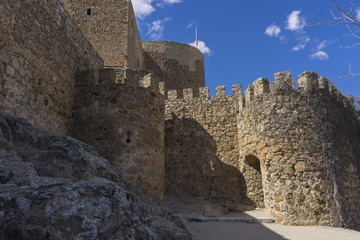 Fototapeta na wymiar Stone walls of a medieval castle. Town of Consuegra in the provi