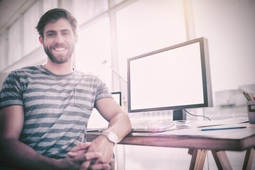 Casual businessman smiling at the camera