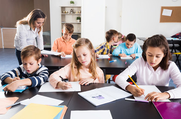 Little children with teacher in classroom