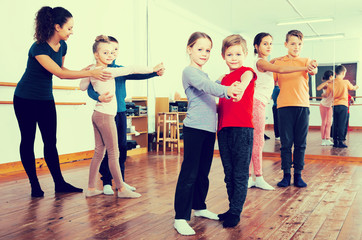 glad little boys and girls dancing pair dance