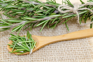 fresh rosemary in a wooden spoon