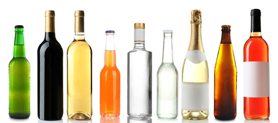 Bottles with different drinks on white background