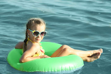 Cute girl swimming on runner ring