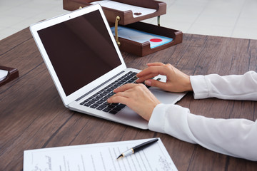 Female lawyer working with laptop in office, close up view