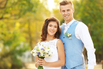 Portrait of beautiful wedding couple on blurred background