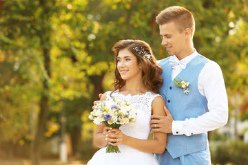 Portrait of beautiful wedding couple on blurred background