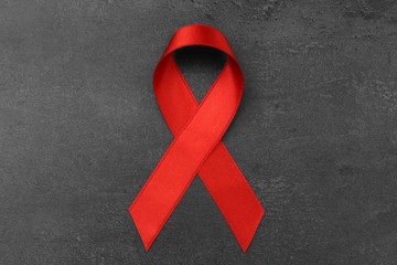 Red ribbon on dark background. Aids concept