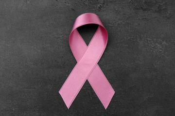 Pink ribbon on dark background. Breast cancer concept