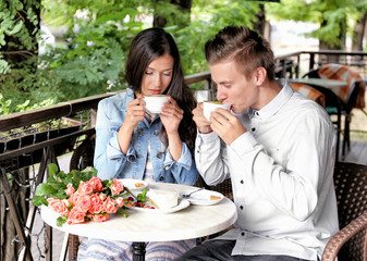 Young couple drinking coffee in cafe