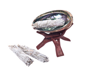 Sage smudge stick and bright polished rainbow abalone shell with wooden cobra stand isolated on white background