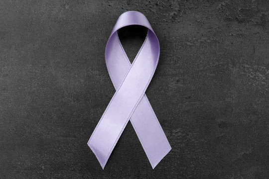 Lavender ribbon on dark background. Cancer and epilepsy concept