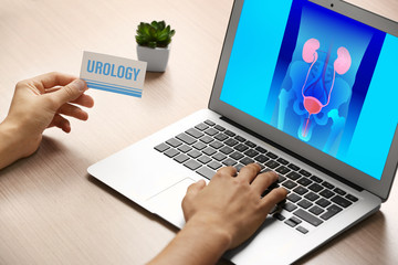 Man searching internet information on urology, close up view