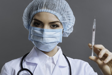 Beautiful doctor preparing to make the injection