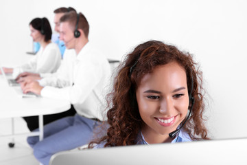 Young female technical support dispatcher working in office, closeup