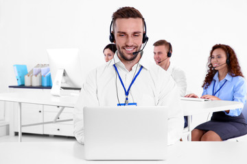 Young male technical support dispatcher working in office, closeup