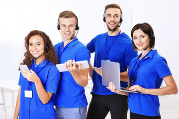 Team of friendly technical support dispatchers in office
