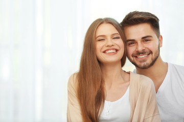 Portrait of cute young couple at home