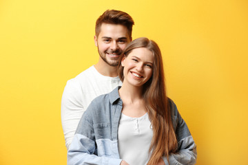 Fototapeta premium Cute young couple on color background