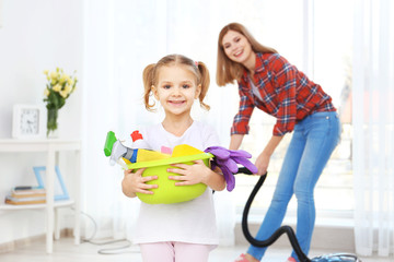 Little girl and her mother doing cleanup at home