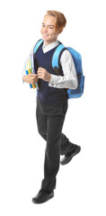 Teenage boy with backpack holding books on white background