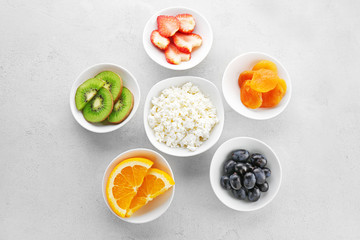 Set of diet products in saucers on grey textured background