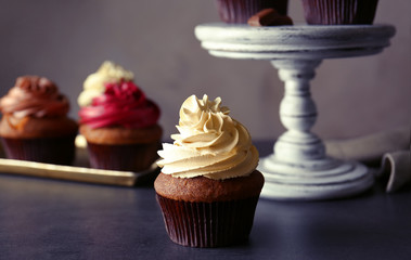 Tasty chocolate cupcake on dark table