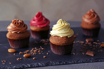 Tasty chocolate cupcakes on dark slate plate