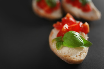 Tasty bruschetta on dark background, closeup