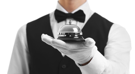 Bellboy holding bell on his hand, close up