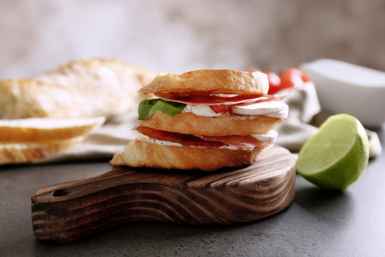 Tasty sandwich on wooden board, closeup