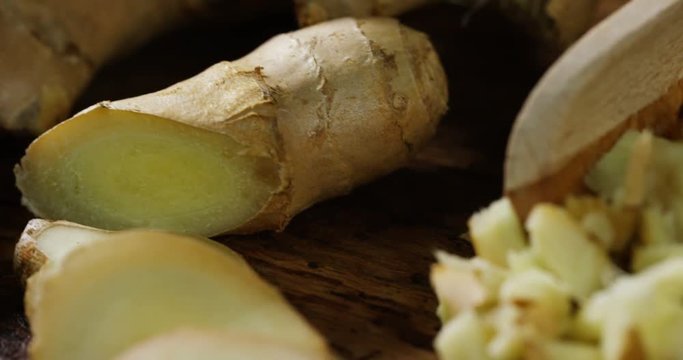 HTML5 Video is required for viewing the video 	hands of a young chef expert grates a piece of colorful and fresh ginger on a wooden work surface 