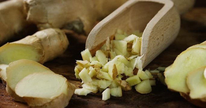 HTML5 Video is required for viewing the video 	hands of a young chef expert grates a piece of colorful and fresh ginger on a wooden work surface 