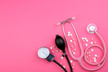 Stethoscope with pills on color background