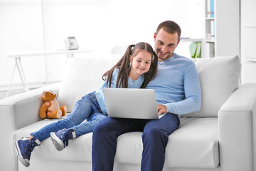 Daughter helping father working at home