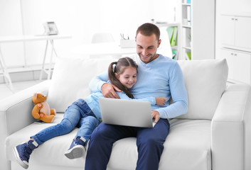 Daughter helping father working at home