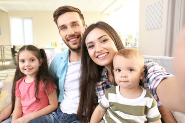 Happy family taking selfie at home