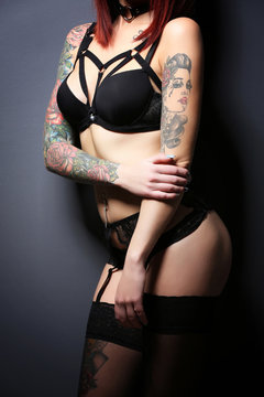 Beautiful girl with tattoo in black lingerie