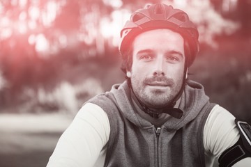 Portrait of male mountain biker riding bicycle in forest