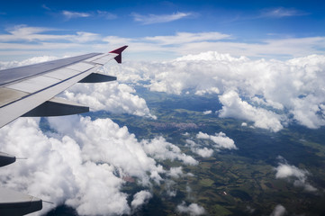 Fototapeta premium View from airplane window. Wing of an airplane flying above the clouds over Foz do Iguassu - Brazil