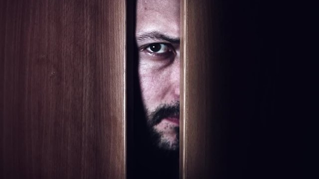 4K Thriller Man Eye Looking in Door Gap, zoom in