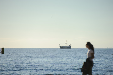 People walking on the beach in the ocean.