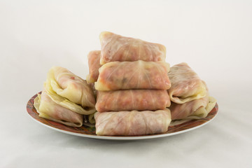 Cabbage rolls on a plate on white background