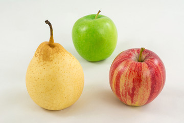 Pear and two apples on a white background