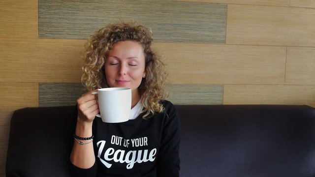 Young Smiling Woman with Cup of Coffee