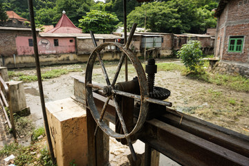 A rusty sluice gate control photo taken in Semarang Indonesia