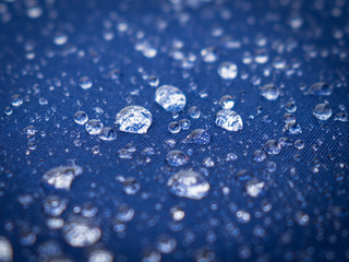 Water droplets on blue canvas