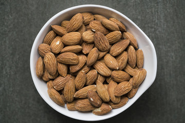 Almond nuts on wood background