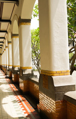 White pillars in arow near a garden photo taken in Semarang Indonesia