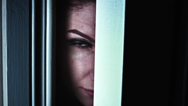 4K Thriller Woman Eye Looking in Door Gap, zoom in