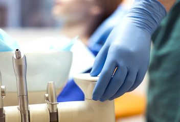 Female hand dentist at the dental office.